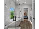 Bright bathroom featuring a standalone tub, walk-in shower, and view into the bedroom at 185 Central Ave, Fayetteville, GA 30214