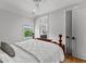 Bright bedroom features hardwood floors, a ceiling fan, window, and ensuite bath at 185 Central Ave, Fayetteville, GA 30214
