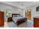 Bedroom with a wooden bed, a ceiling fan, two windows, and doors leading to an outside patio at 185 Central Ave, Fayetteville, GA 30214