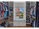 Walk-in closet with custom shelving, built-in window bench, and hardwood floors at 185 Central Ave, Fayetteville, GA 30214