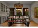 Elegant dining room with a rustic wood table, modern chandelier, and natural light at 185 Central Ave, Fayetteville, GA 30214