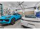 Spacious garage featuring two Porsche vehicles, overhead storage, and bike racks at 185 Central Ave, Fayetteville, GA 30214