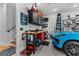 Organized garage featuring tool storage, bike racks, epoxy flooring, and a Porsche vehicle at 185 Central Ave, Fayetteville, GA 30214