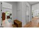 Hallway view with wooden bench and hooks, opens to bedroom, features hardwood floors and white painted shiplap at 185 Central Ave, Fayetteville, GA 30214