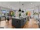 Open kitchen layout with an island and modern appliances flowing into the living room area at 185 Central Ave, Fayetteville, GA 30214