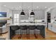 Kitchen with gray cabinets, quartz countertops, a large island with seating, and black pendant lighting at 185 Central Ave, Fayetteville, GA 30214
