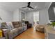 Inviting living room features a ceiling fan, hardwood floors, comfortable seating, and a media center at 185 Central Ave, Fayetteville, GA 30214