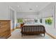 Bright bedroom featuring hardwood floors, a cozy area rug, a queen bed, and multiple windows for ample natural light at 185 Central Ave, Fayetteville, GA 30214