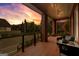 Inviting covered porch with comfortable seating area with view of other homes in the neighborhood at sunset at 185 Central Ave, Fayetteville, GA 30214
