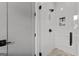 Tiled shower with glass door and sleek black hardware at 185 Central Ave, Fayetteville, GA 30214
