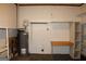 Unfinished basement area features a water heater, work bench and shelving at 8469 Shiloh Ct, Jonesboro, GA 30238