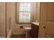 Bathroom features a tub, toilet, window and sink with cabinet at 8469 Shiloh Ct, Jonesboro, GA 30238