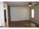 Living room featuring neutral walls, ceiling fan and a view into other rooms at 8469 Shiloh Ct, Jonesboro, GA 30238
