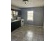 Kitchen featuring tile floors, appliances, window, and dark cabinets at 1810 Highway 138 E, Stockbridge, GA 30281