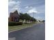 View of Woodland Middle School sign on a building along a road with trees at 1810 Highway 138 E, Stockbridge, GA 30281