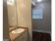 Bathroom vanity featuring a sink with a window-lit view from the bathroom entrance at 4196 Lehigh Blvd, Decatur, GA 30034