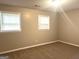 Bright bedroom featuring neutral carpet, light walls, and two windows at 4196 Lehigh Blvd, Decatur, GA 30034