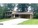 A split-level home with brick and siding, a covered carport, and a long driveway at 4196 Lehigh Blvd, Decatur, GA 30034