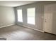 Bright living room with neutral carpet, fresh paint, and two sunny windows at 4196 Lehigh Blvd, Decatur, GA 30034