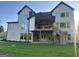 The rear of a home featuring a covered patio, second story deck, and a lush green lawn at 1291 E M Croy Rd, Sugar Hill, GA 30518