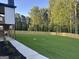 Expansive backyard with lush green grass, privacy fence, and mature trees offering serenity and seclusion at 1291 E M Croy Rd, Sugar Hill, GA 30518