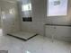 Modern bathroom featuring marble tile, a sleek shower, and minimalist fixtures for a spa-like feel at 1291 E M Croy Rd, Sugar Hill, GA 30518