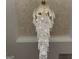 An elegant, tiered crystal chandelier hangs from a beautifully textured ceiling, adding luxury to the home at 1291 E M Croy Rd, Sugar Hill, GA 30518