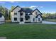 Beautiful white brick home featuring black trim, a well manicured lawn, and a contemporary design at 1291 E M Croy Rd, Sugar Hill, GA 30518