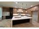 Spacious kitchen with a large island, modern appliances, custom cabinets and pendant lighting at 1293 E M Croy Rd, Sugar Hill, GA 30518