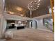 Open-concept living room with soaring ceilings, hardwood floors, and a modern chandelier at 1293 E M Croy Rd, Sugar Hill, GA 30518