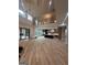 Bright open-concept living room with high ceilings, hardwood floors, and view into modern kitchen at 1293 E M Croy Rd, Sugar Hill, GA 30518