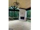 Covered deck with a stone fireplace, wood floors, and wood ceiling with fan at 1293 E M Croy Rd, Sugar Hill, GA 30518