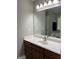 Bathroom with a large mirror, a white countertop, and a wooden vanity with modern faucets at 2074 Ayers Creek Ct, Villa Rica, GA 30180