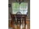 Dining room with a wooden table, four chairs and a window, complemented by hardwood floors at 2074 Ayers Creek Ct, Villa Rica, GA 30180