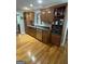 Kitchen with stainless steel dishwasher and sink, and a built-in storage cabinet, all set against hardwood flooring at 2074 Ayers Creek Ct, Villa Rica, GA 30180