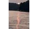 A calm lake view with the sun rising, and its reflection shimmering on the water's surface at 2074 Ayers Creek Ct, Villa Rica, GA 30180