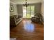 Living room with a comfortable couch and chair next to a bright window, complete with hardwood floors at 2074 Ayers Creek Ct, Villa Rica, GA 30180