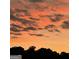 Beautiful sunset with orange and gray clouds over the silhouette of trees at 2074 Ayers Creek Ct, Villa Rica, GA 30180