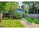 Side of property featuring beautiful green grass, an inviting outdoor walkway, and an abundance of plant life at 638 Mcgruder Ne St, Atlanta, GA 30312