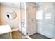 Bathroom features a modern shower with a glass enclosure and marble tiling at 638 Mcgruder Ne St, Atlanta, GA 30312