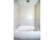 A modern bathtub features marble tiling and silver colored fixtures at 638 Mcgruder Ne St, Atlanta, GA 30312