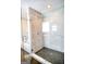 Bathroom features a modern shower with a glass enclosure and marble tiling at 638 Mcgruder Ne St, Atlanta, GA 30312