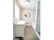 Bright bathroom featuring a marble countertop vanity, decorative mirror, and a modern glass shower at 638 Mcgruder Ne St, Atlanta, GA 30312