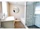 Bathroom showcasing tub, modern shower with glass enclosure and marble tiling at 638 Mcgruder Ne St, Atlanta, GA 30312