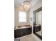 Charming bathroom features granite counters, a decorative chandelier and striking black and white mosaic tile flooring at 638 Mcgruder Ne St, Atlanta, GA 30312