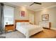 Cozy bedroom with carpet, a fan, two side tables, and a bed with white comforter at 638 Mcgruder Ne St, Atlanta, GA 30312