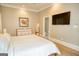 Neutral bedroom with view to bath features a decorative pheasant art piece at 638 Mcgruder Ne St, Atlanta, GA 30312