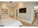 Neutral bedroom features a decorative pheasant art piece and view to hall at 638 Mcgruder Ne St, Atlanta, GA 30312
