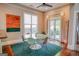 Dining area with a glass table, art, ceiling fan, and patio doors, blending indoor-outdoor living at 638 Mcgruder Ne St, Atlanta, GA 30312