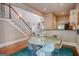 Bright dining area with a glass table, colorful chairs, and stairway to the second floor at 638 Mcgruder Ne St, Atlanta, GA 30312
